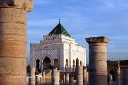 Image du Maroc Professionnelle de  Le tombeau du plus populaire des sultans du Maroc, Mohammed V, père de l’indépendance repose ici dans cette  demeure bâtie en marbre blanc et couronnée par un toit pyramidale orna de tuiles vertes, symbole de la royauté. Sa construction a nécessita une dizaine d’année, au premier plan  les colonnes de l’esplanade de la Mosquée Hassan à Rabat, Jeudi 1er Mars 2007. (Photo / Abdeljalil Bounhar)
 